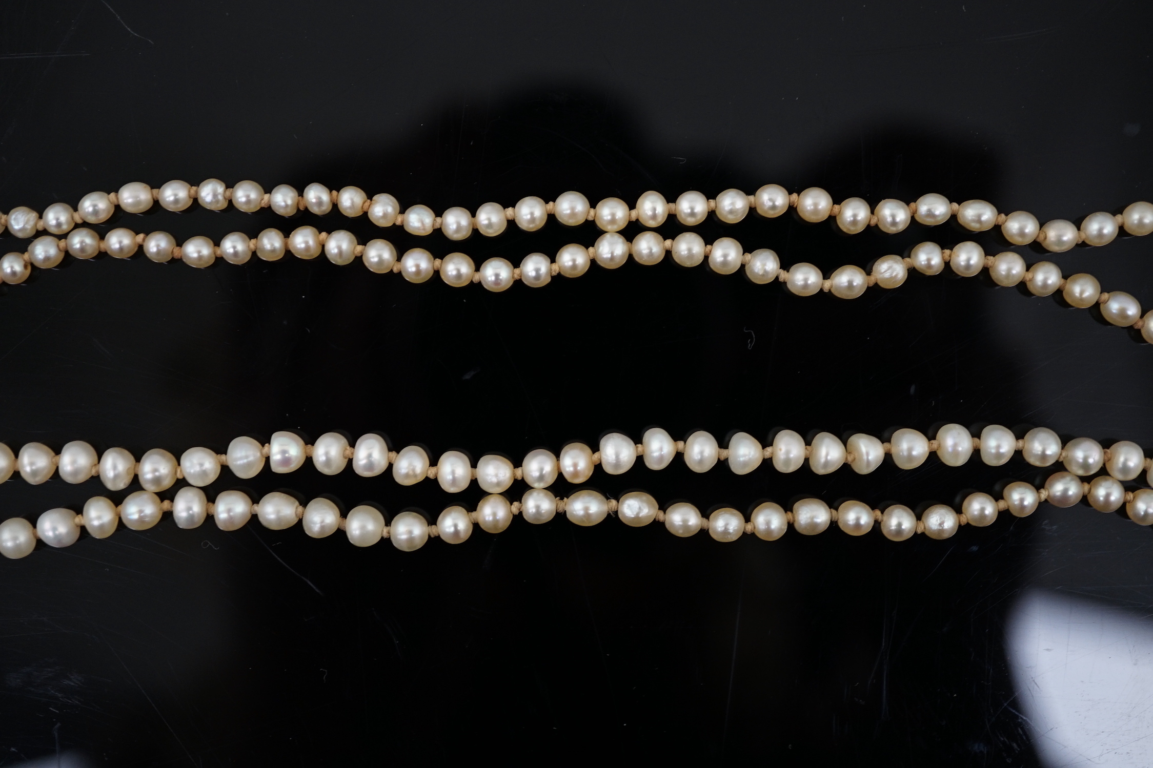 A Victorian single strand graduated natural saltwater pearl necklace, with seed pearl and enamel set gold clasp